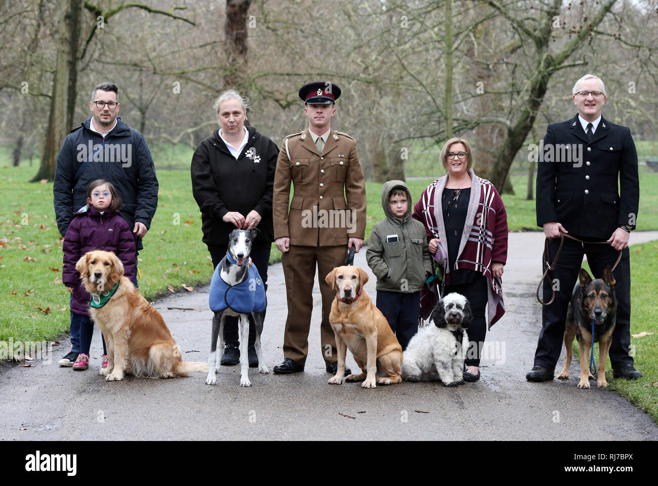 The finalists for the prestigious Crufts dog hero competition, Friends for Life 2019, (left to right) Steve Gunn, his daughter Milli and their dog Emma, Sarah Candy and her dog Ringo, Private Lee Hampson and his dog Lance, Becky Gaye, her son Oli, and their dog Snoopy, and PC David Wardell and his dog Finnattend a launch event for this year's Crufts and the Friends for Life dog hero finalists at the Kennel Club in London. Stock Photo