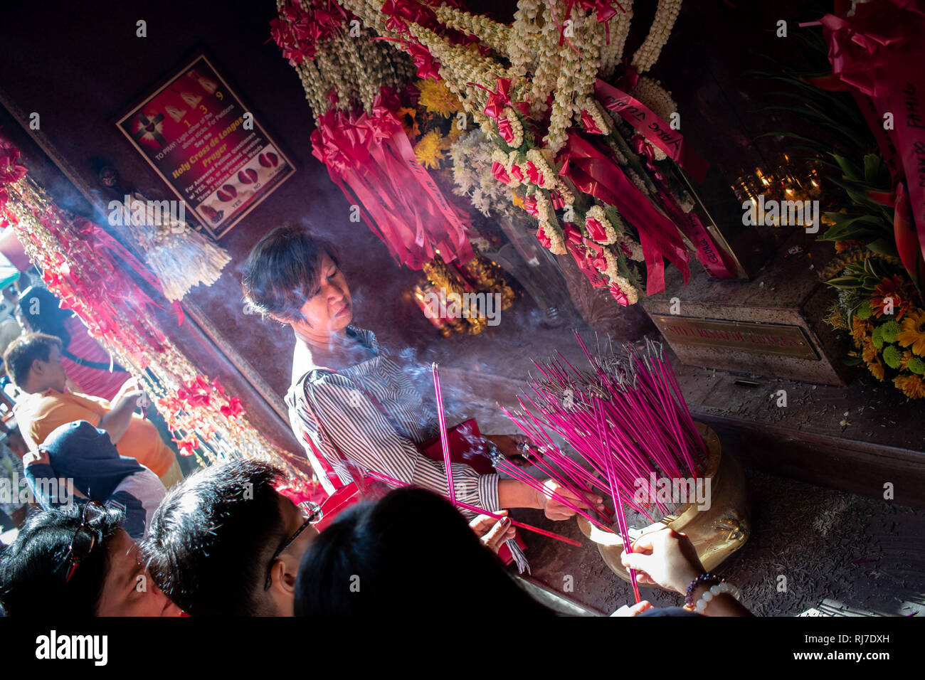 Manila, Philippines. 05th Feb, 2019. People also burn incense, make offerings, and pray on Sto. Cristo de Longos cross that is located in Ongpin and Tomas Pinpin Street. It is believed by the locals that it cures people and answer the prayers of the devotees. Credit: Alfredo Ruzol/Pacific Press/Alamy Live News Stock Photo