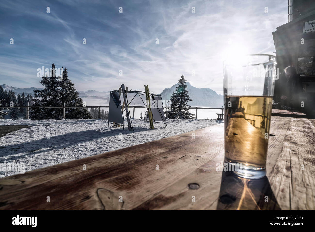 Berglandschaft im Winter am Tegelberg in Süddeutschland, Pause auf einer Berghütte, Getränk auf einem Holztisch Stock Photo