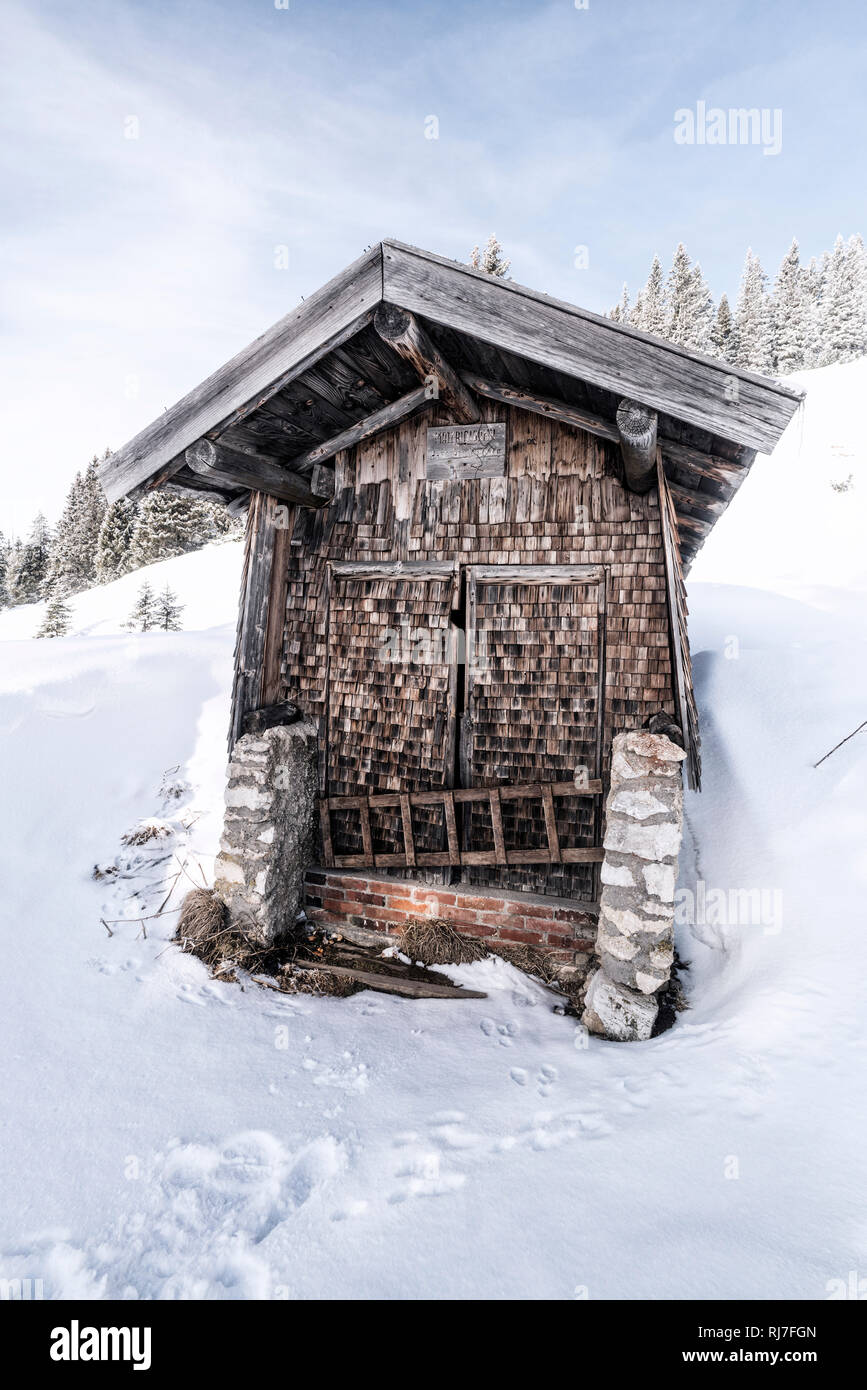 Kleine Hütte mit Holzschindeln im Winter am Tegelberg in Süddeutschland, Stock Photo