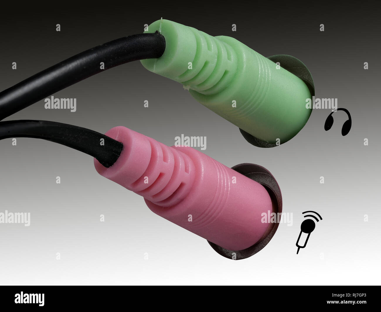 Plug for headphones, headsets and microphone on a computer, gray, white background, right side