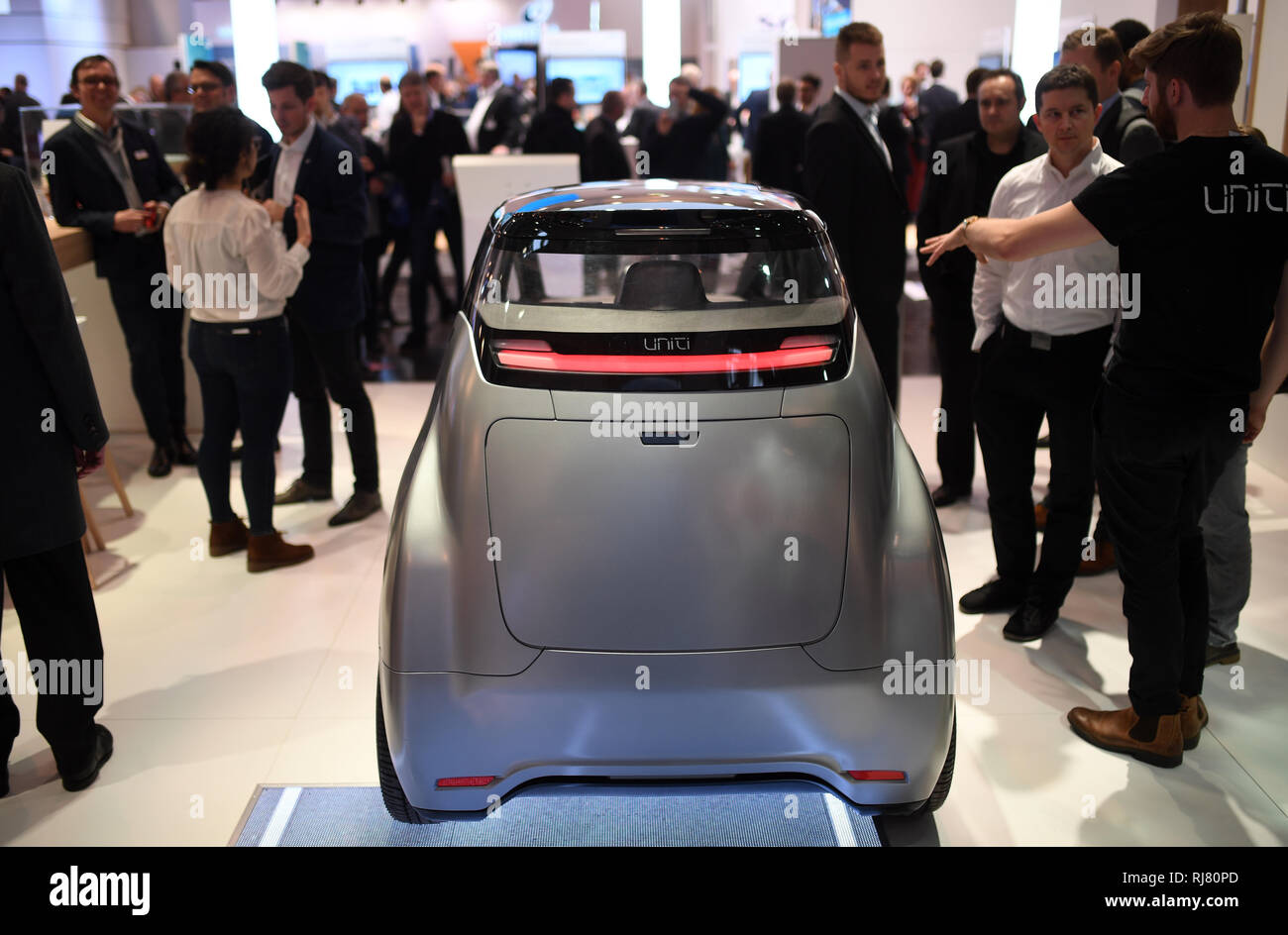 Essen, Germany. 05th Feb, 2019. Visitors stand next to the Swedish electric  car Uniti One at the stand of energy supplier E.ON at the "E-world energy &  water" trade fair. From 5