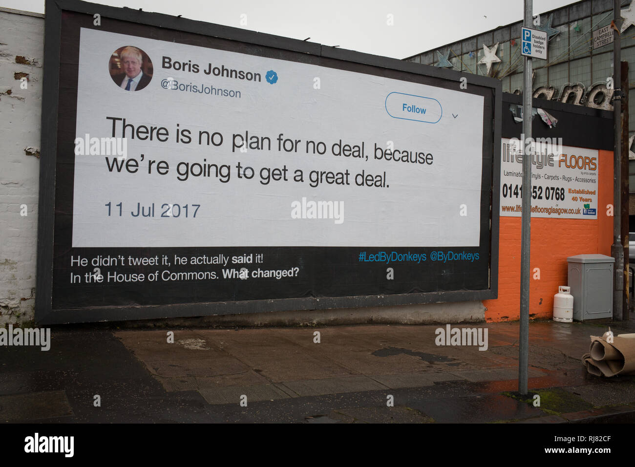 Glasgow, Scotland, 5th February 2019. Billboard by the anti-Brexit group 'Led By Donkeys', showing a quote from Conservative Party MP Boris Johnson in which he talks of the great deal Great Britain would get on leaving the EU, in the East End of Glasgow, Scotland, 5 February 2019. The guerilla billboard campaign is the initiative of six friends who crowdfunded money to be able to post what they believe are the 'country's biggest lies'.  Image Credit: Jeremy Sutton-Hibbert/Alamy Live News. Stock Photo