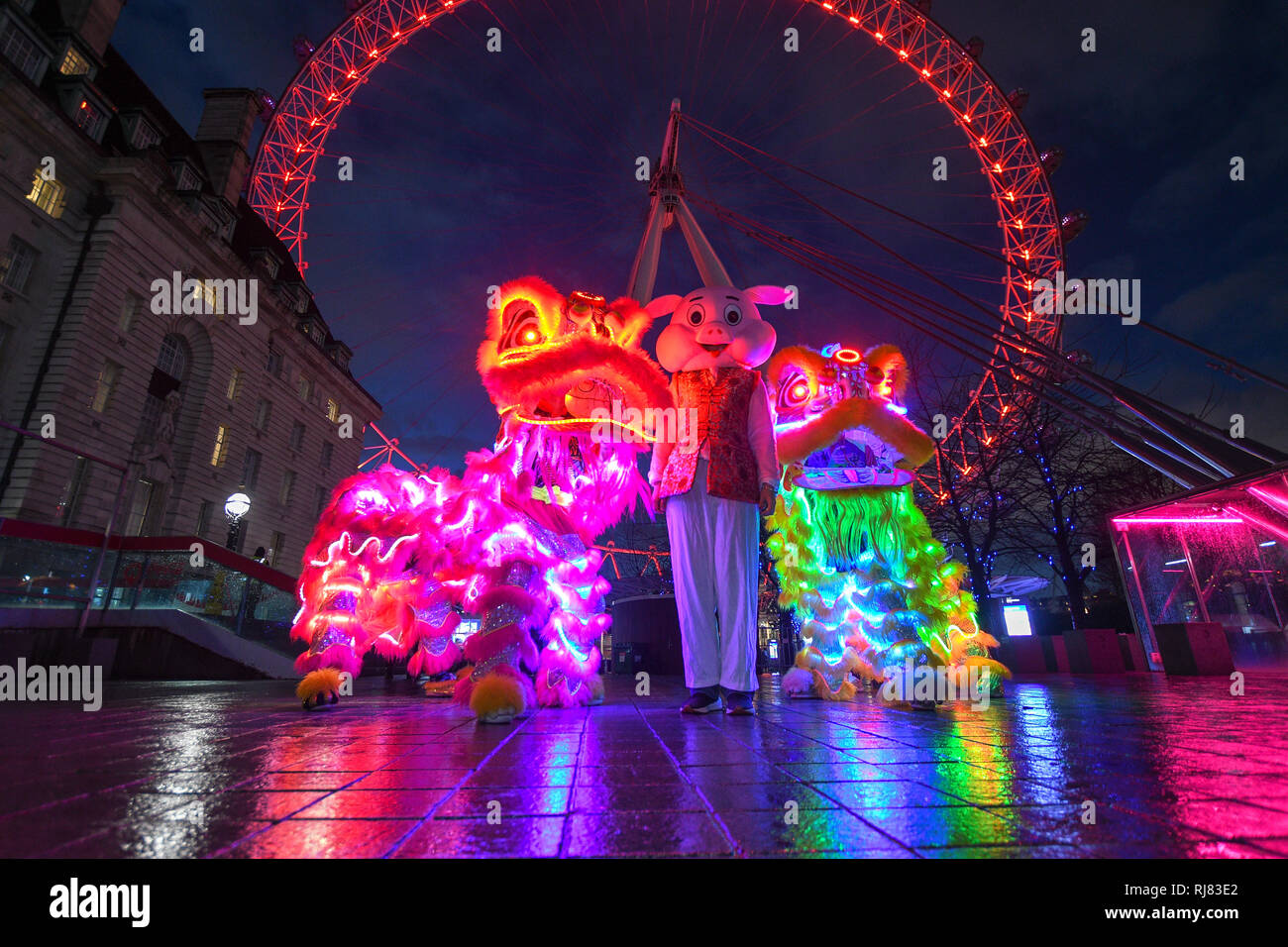 Chinese new year at the London Eye, its the year of the pig and the eye turned red and gold to celebrate the new year. LCCA Festival of Spring Celebrations in London. Stock Photo