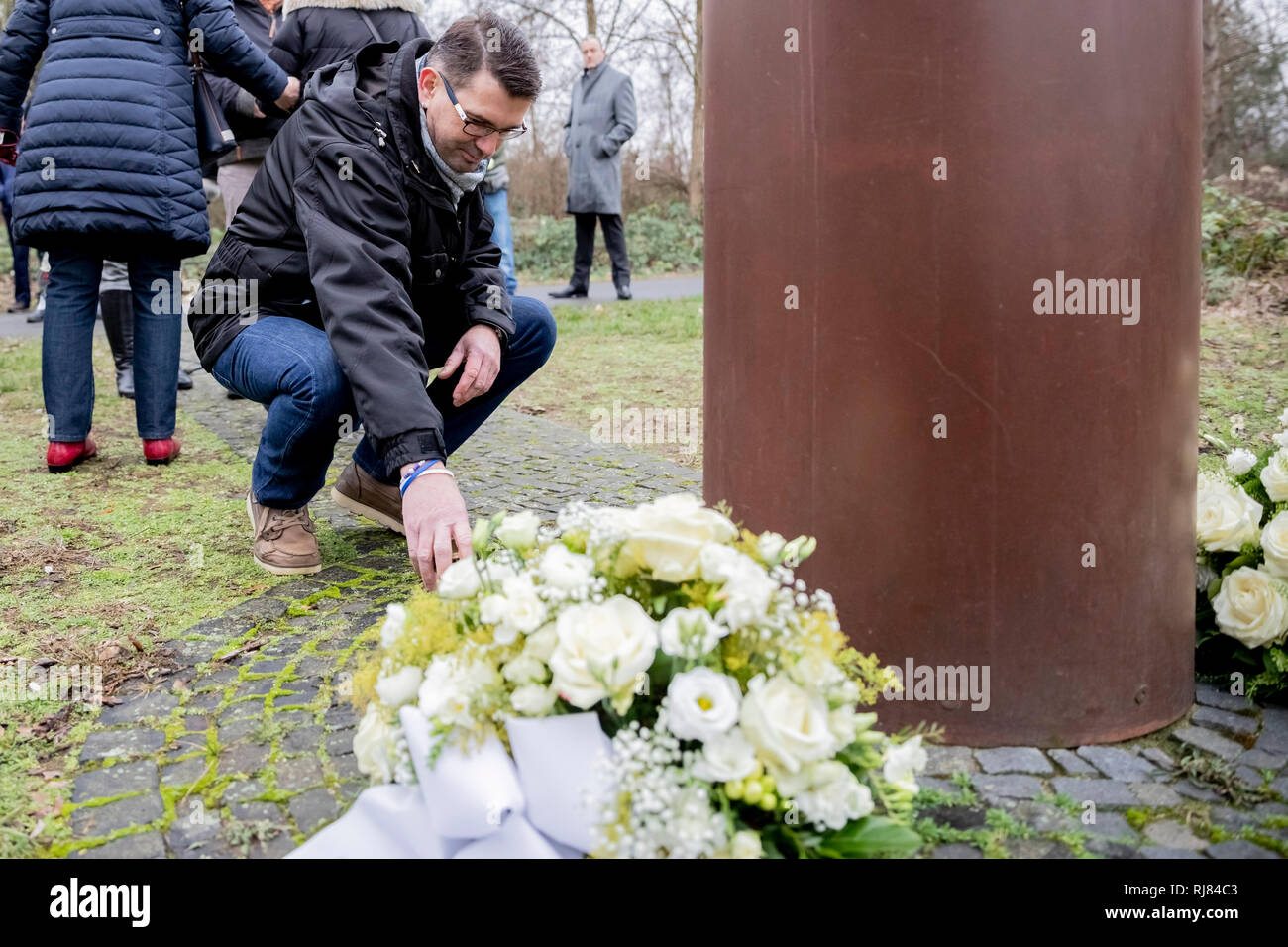 Berlin, Germany. 05th Feb, 2019. Stephan Gueffroy, brother of Chris Gueffroy, kneels at a memorial to the 30th anniversary of his brother's death in front of a memorial stele at the Britzer branch canal. There Gueffroy was shot 30 years ago during an escape attempt at the Berlin Wall. He's the last person to die using a firearm. Credit: Christoph Soeder/dpa/Alamy Live News Stock Photo
