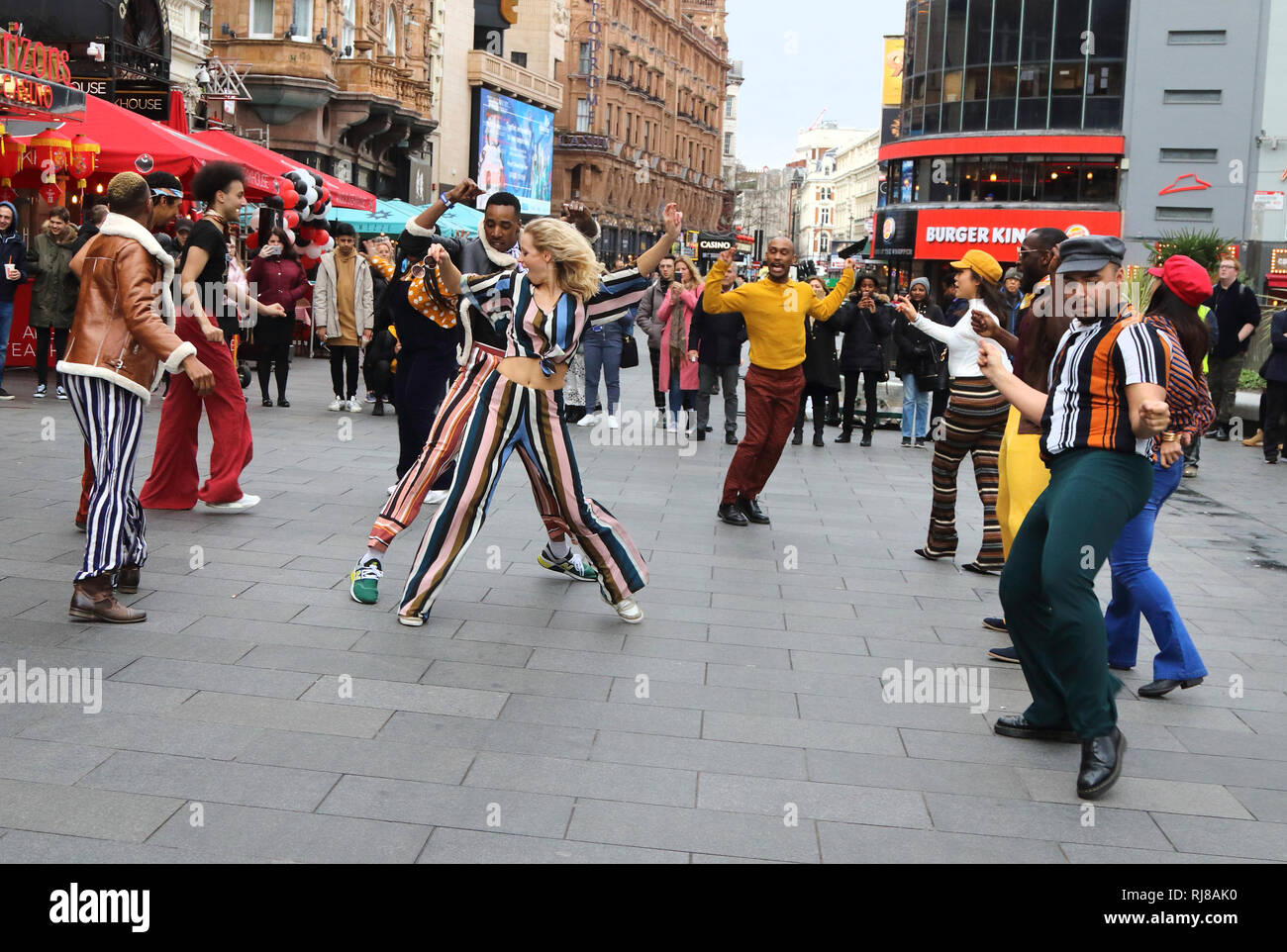 The American Soul crew seen dancing together in the streets of London. In honour of the BET (Black Entertainment Television) Network’s groovy new period drama, American Soul, a flash mob dance take-over on the streets of London. Stock Photo