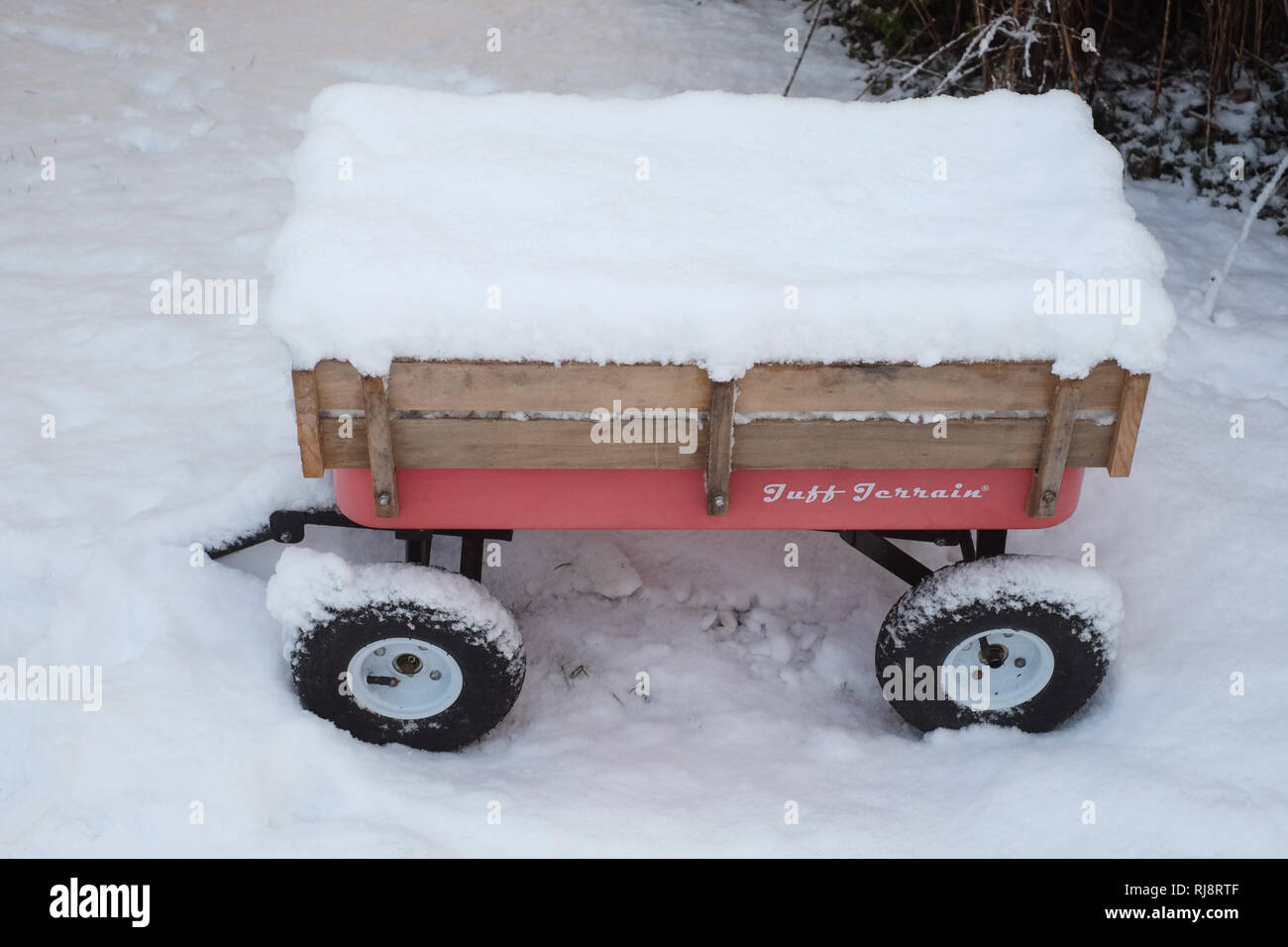 Hand cart or wagon covered in snow, Medstead, Alton, Hampshire, England ,United Kingdom. Stock Photo