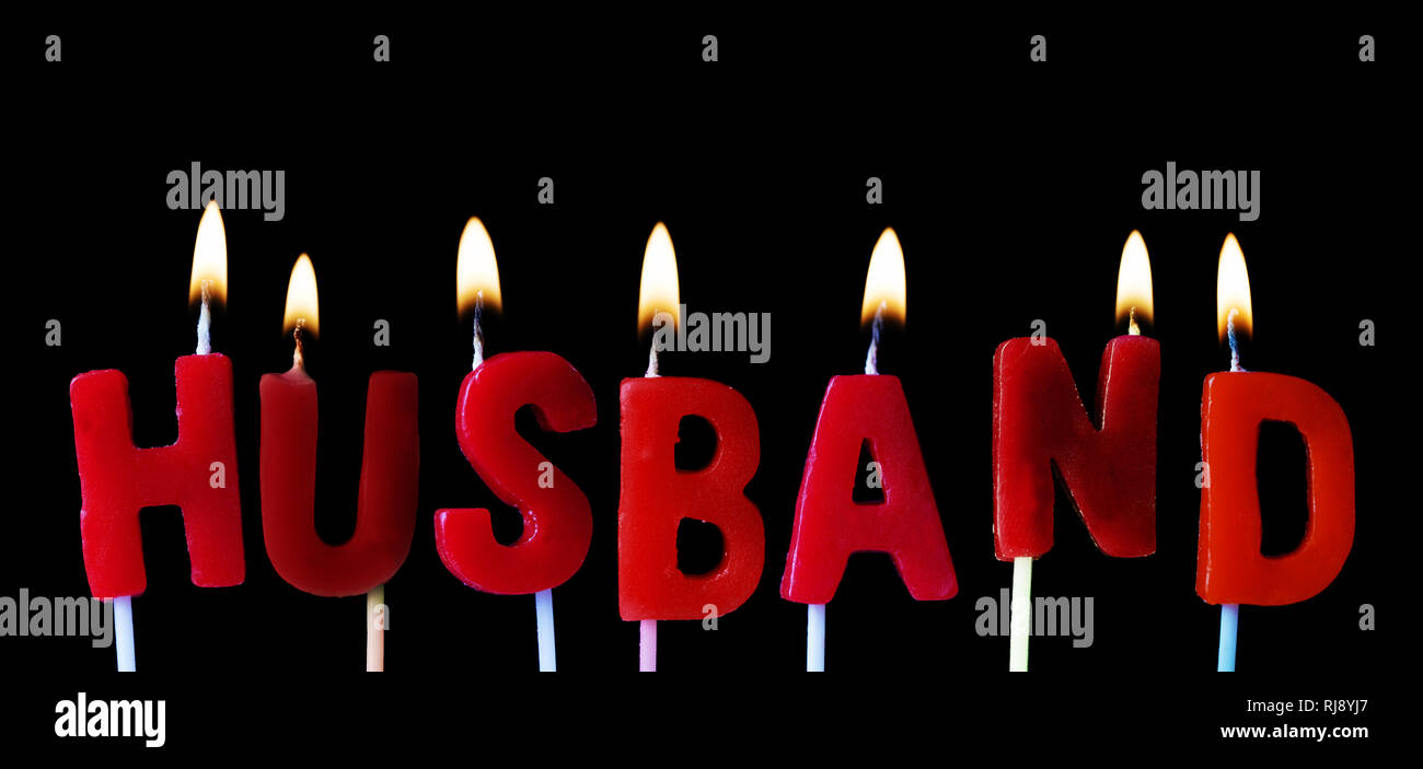Husband spellt out in red birthday candles against a black ...