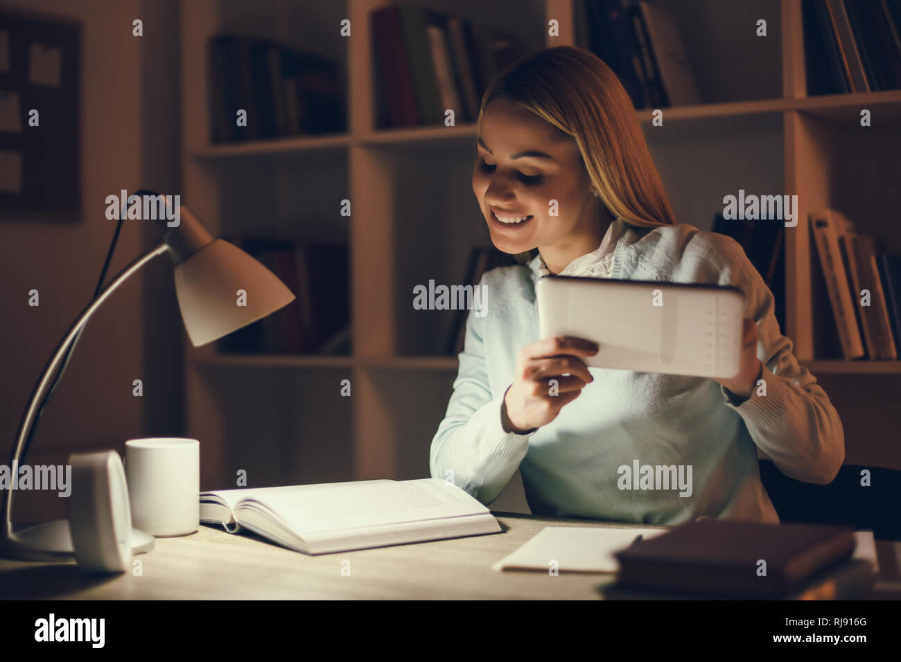 Student learning at home. Using digital tablet. Stock Photo