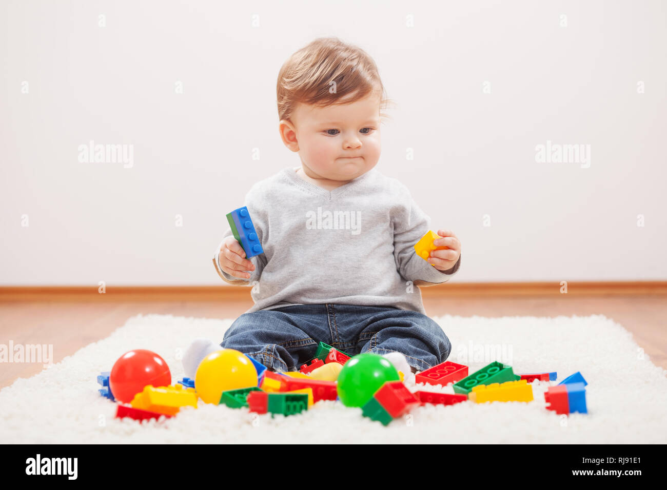 Little boy playing with blocks Stock Photo - Alamy
