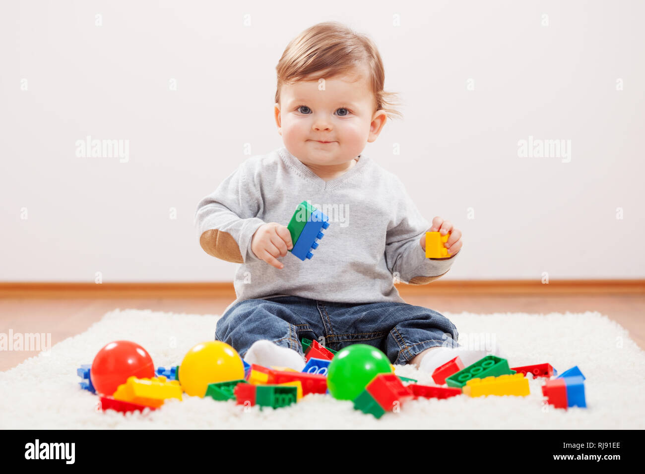 Little boy playing with blocks Stock Photo - Alamy
