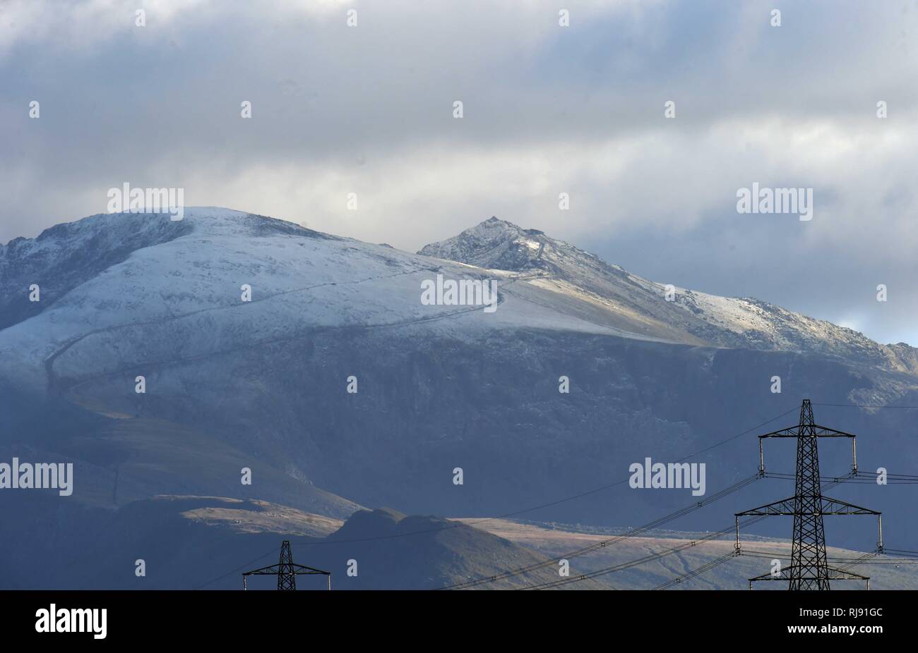 Firts snow of the winter in Snowdonia taken from Anglesey, Snowdon, Sunday 28th October 2018. Stock Photo
