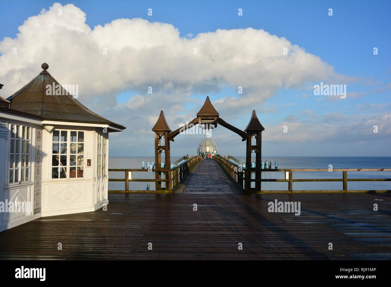 View through a wooden arch to the diving gondola on the pier in Sellin, on Rügen in Germany Stock Photo