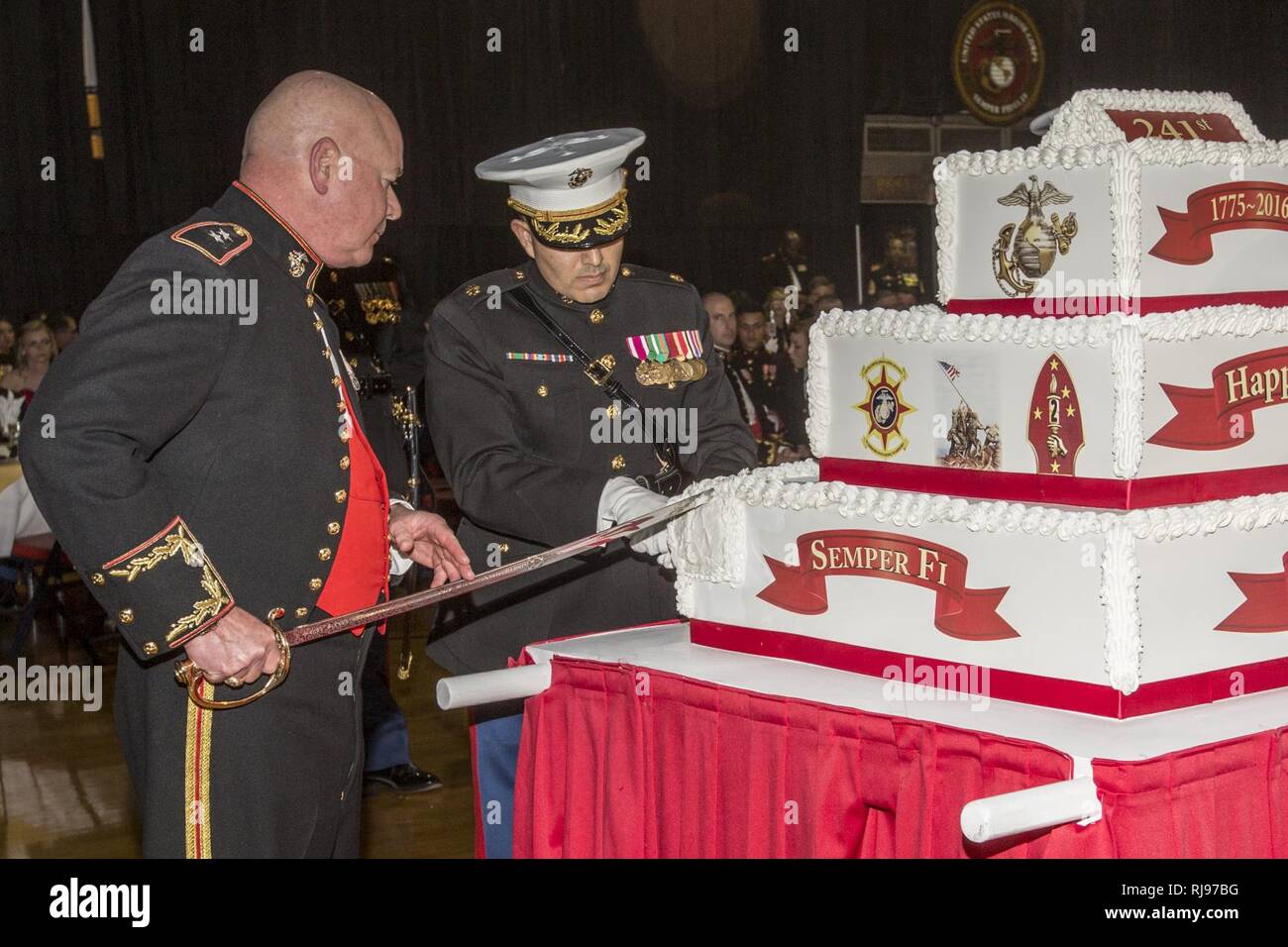 U.S. Marine Corps Maj. Gen. Walter L. Miller, Jr., commanding general of II Marine Expeditionary Force (II MEF), left, cuts a cake at the II MEF Marine Corps Birthday Ball at Marine Corps Base Camp Lejeune, N.C., Nov. 5, 2016. Commandant of the Marine Corps Gen. Robert B. Neller attended the birthday ball as the guest of honor. Stock Photo