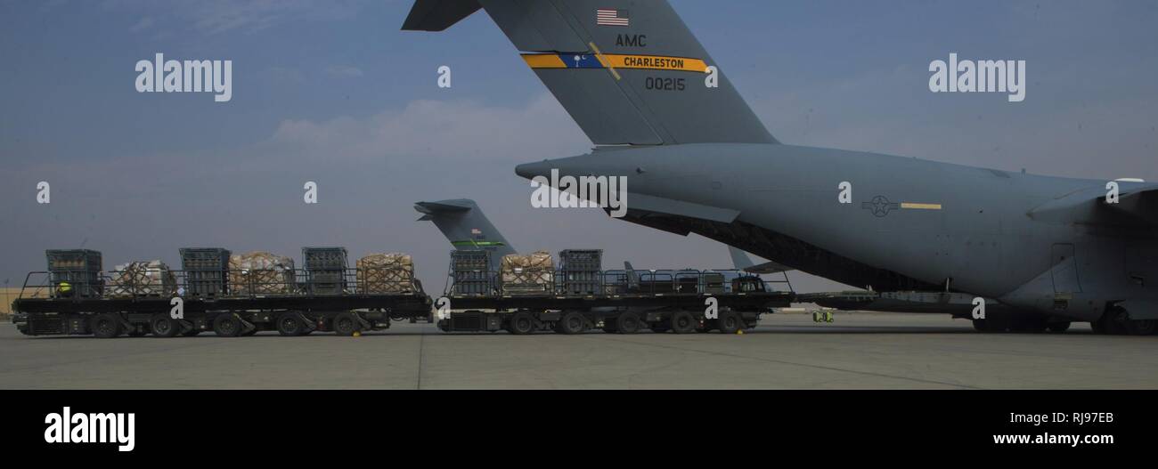 Member of the 455th Expeditionary Logistics Readiness Squadron unload pallets out of an 816th Expeditionary Airlift Squadron C-17 Globemaster III in support of Operation Freedom’s Sentinel Nov. 3, 2016. The operation focuses on training, advising, and assisting the Afghan Security Institutions and Afghan National Defense and Security Forces in order to build their capabilities and long-term sustainability. Stock Photo