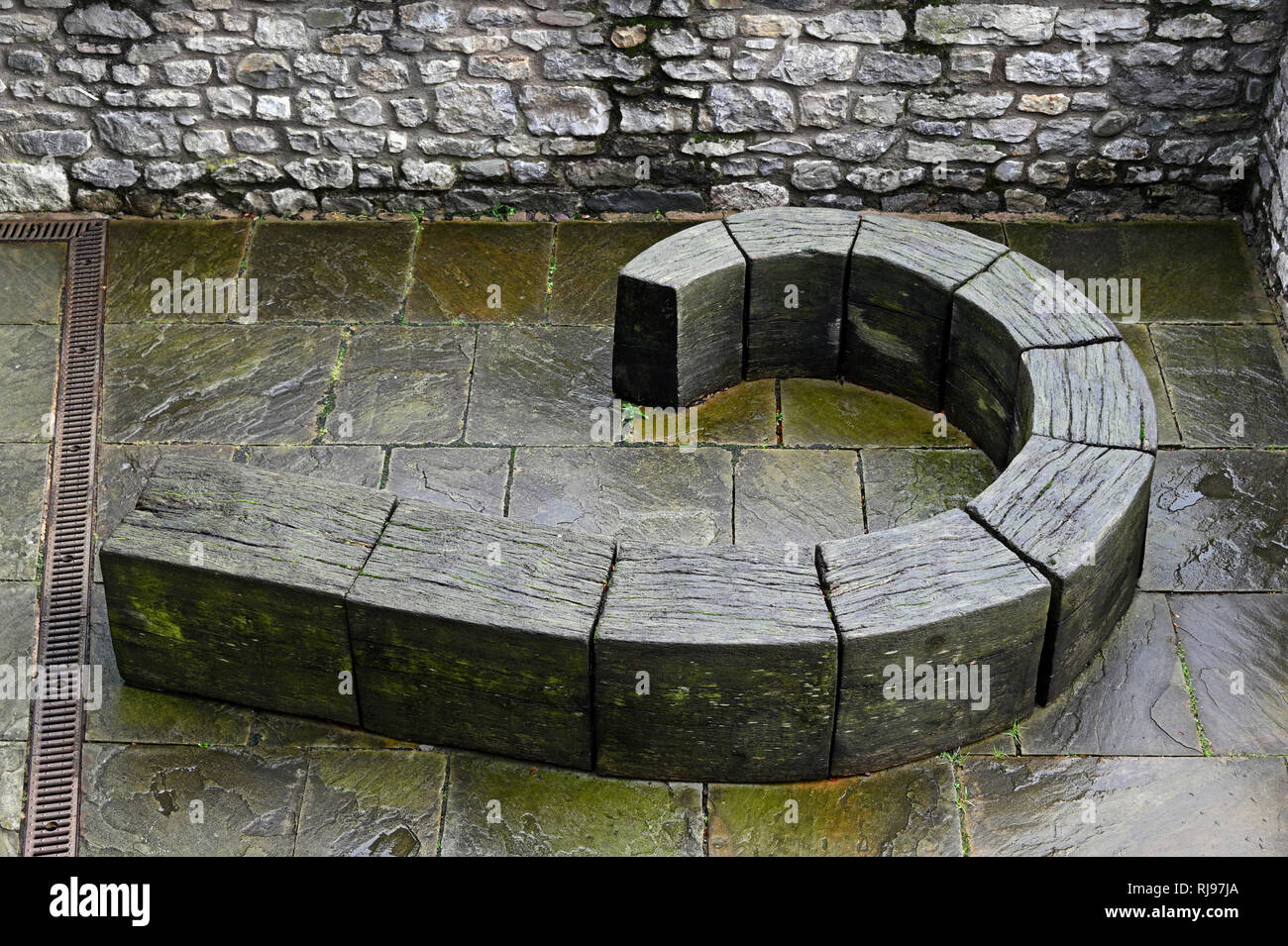 Curved wooden seat outdoor artwork. The Brewery Arts Centre, Kendal, Cumbria,. England, United Kingdom, Europe. Stock Photo