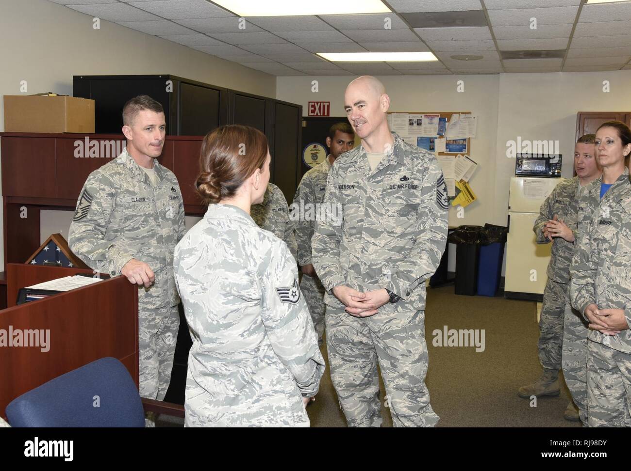 Chief Master Sgt. Ronald C. Anderson, Air National Guard command chief master sergeant, visits with Staff Sgt. Martina Dodge, Headquarters, South Dakota Air National Guard human resources personnel assistant, and other Airmen, Nov. 6, 2016.  As the highest level of enlisted leadership, Chief Anderson is responsible for matters influencing the health, morale, welfare and professional development of more than 105,400 Air Guard members. Stock Photo