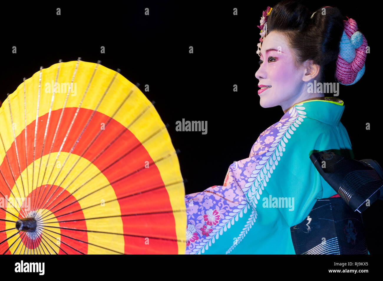 Florence, Italy - November 18, 2017: Beautiful japanese young woman in traditional kimono, with umbrella, dance during a show at 'Japanese Festival 20 Stock Photo