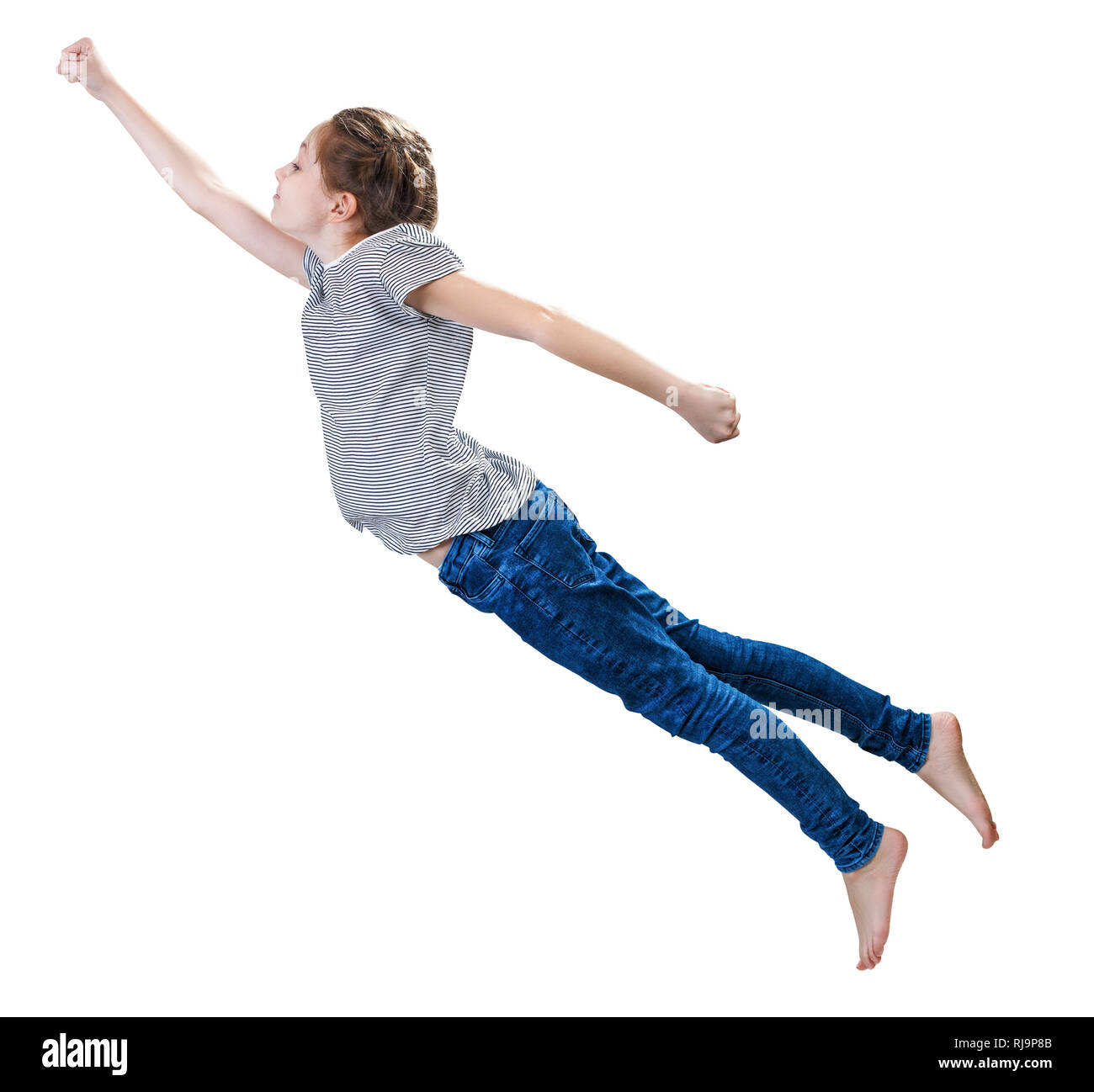 Little girl flying in the superman pose. Stock Photo
