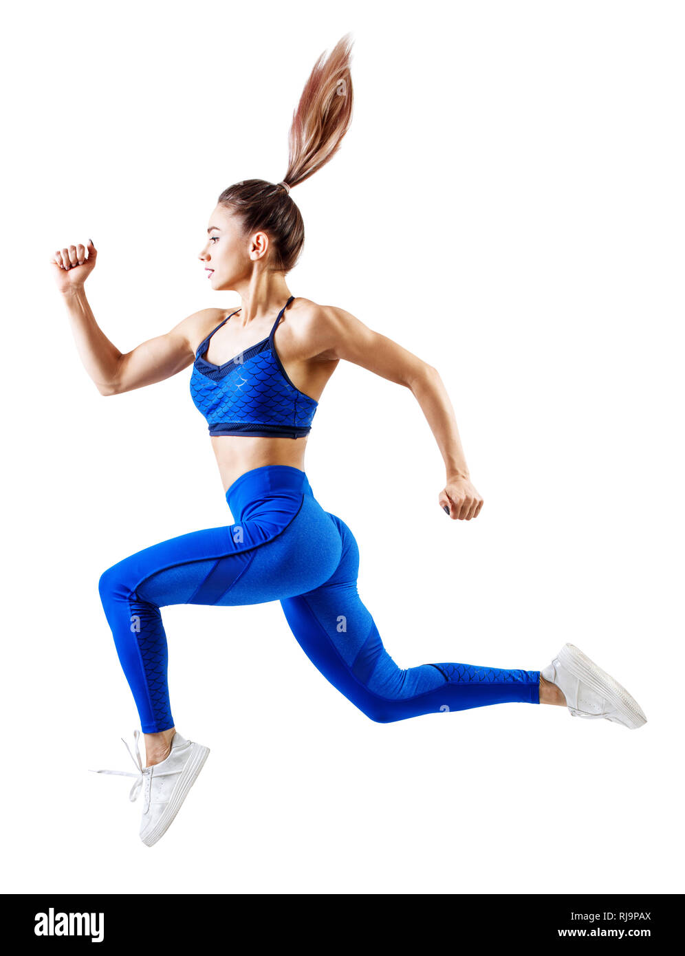 Young woman runner in blue sportswear jump in the air. Stock Photo