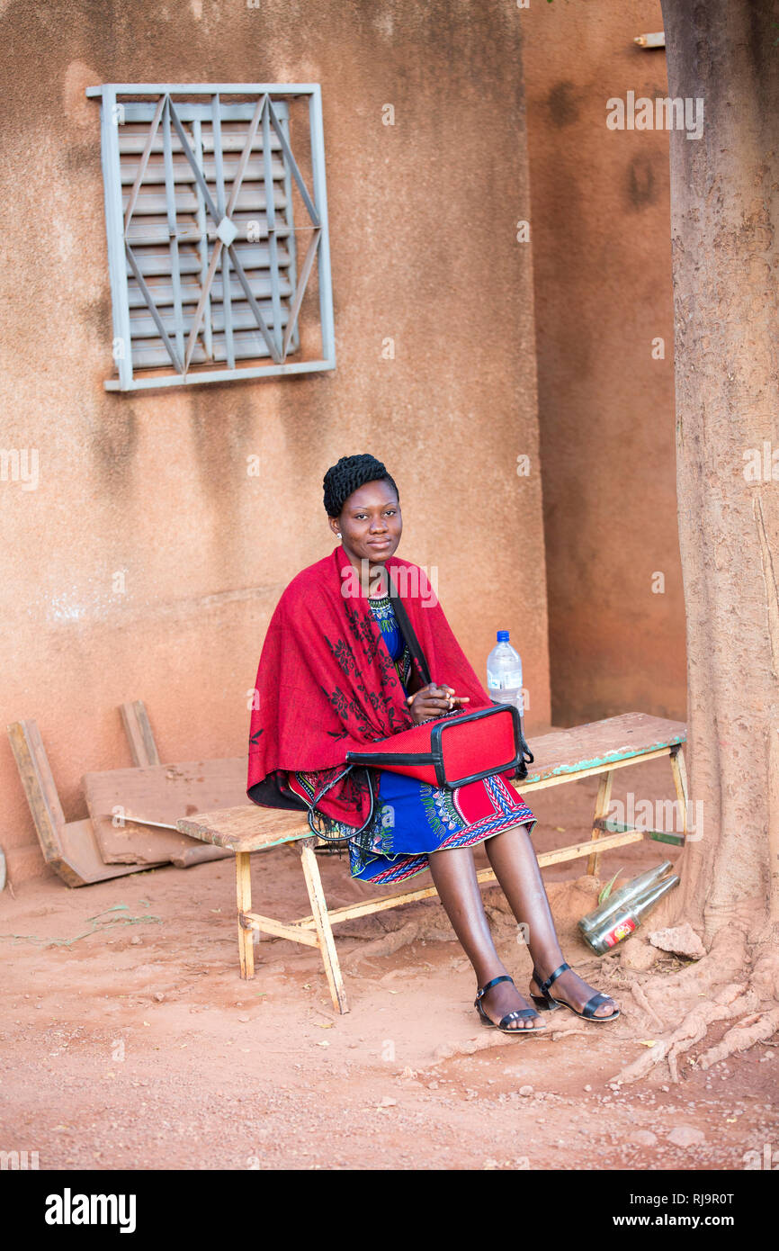 SEMUS compound Yako, Burkina Faso, 29th November 2016; Young woman working as a translator. Stock Photo