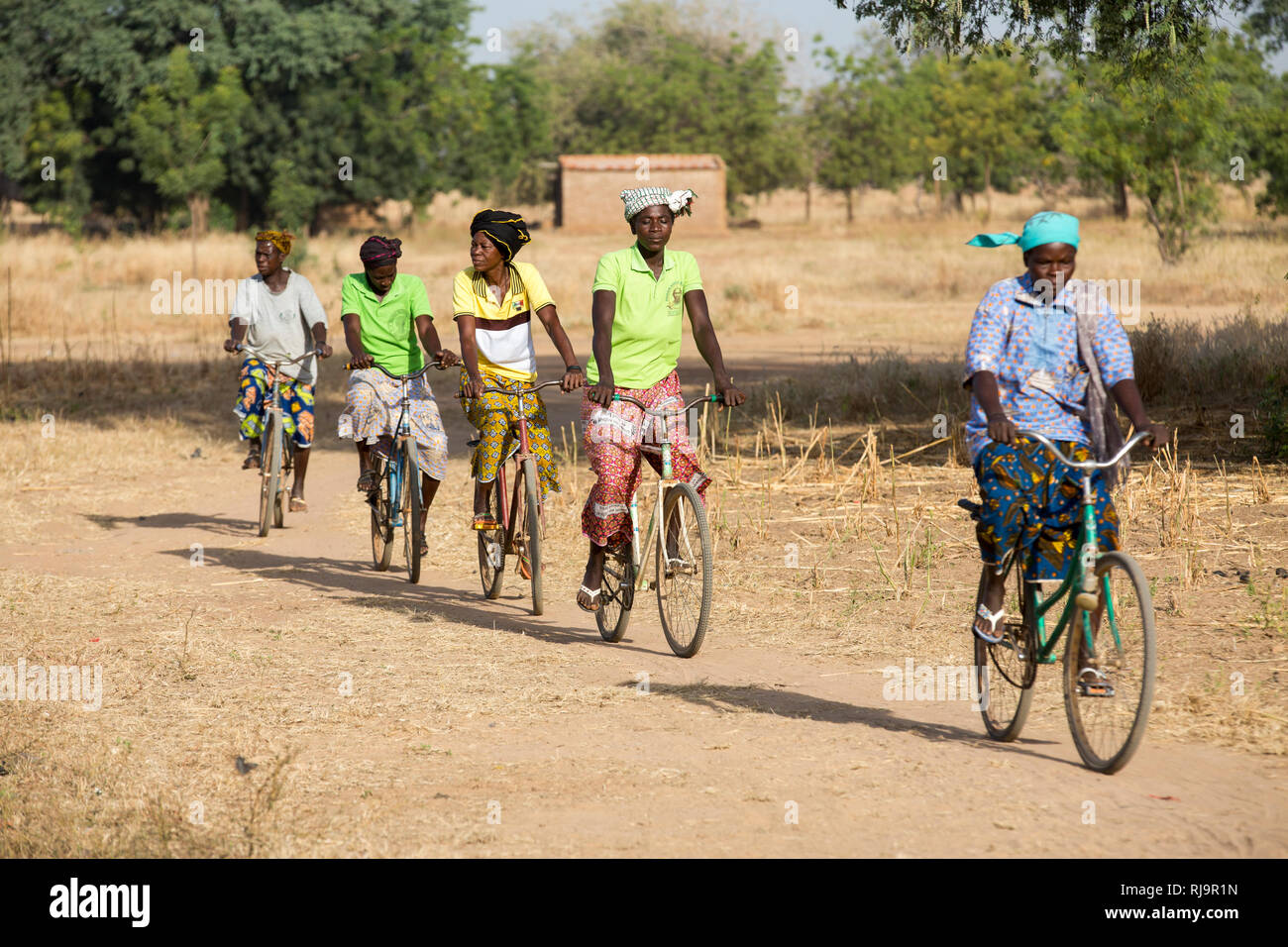 Bissiga Village, Yako, Burkina Faso, 29th November 2016; Village women who are members of the Woman's Forest Livelihood project, on their way to take part in the day's activities. Stock Photo