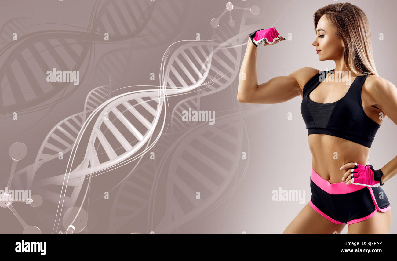 Athletic fitness woman standing among DNA chains. Stock Photo