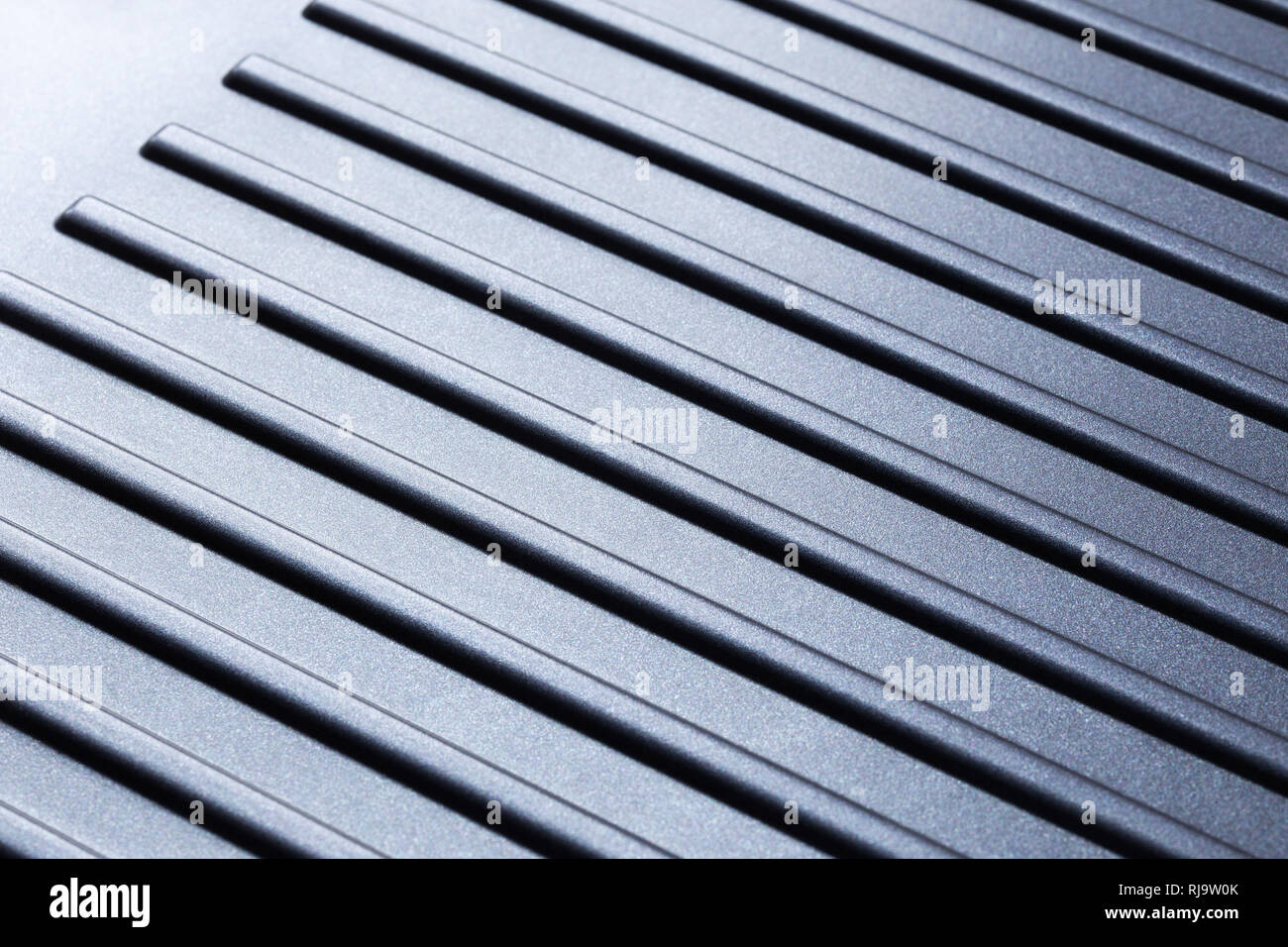 Abstract diagonal gradient striped background from modern high-tech material. Stock Photo