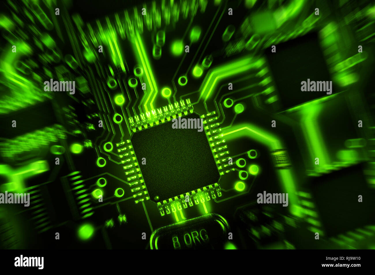 Circuit board with components in green tones. Abstract high tech background. Zoom effect. Stock Photo