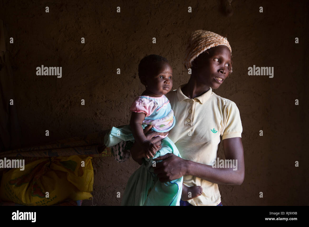 Yarsi village, Yako, 1st December 2016;  Leontine Ouedraogo, a member of the Village Tree Enterprise Shea Group with her 5 month old baby Saminatou Dem. Stock Photo