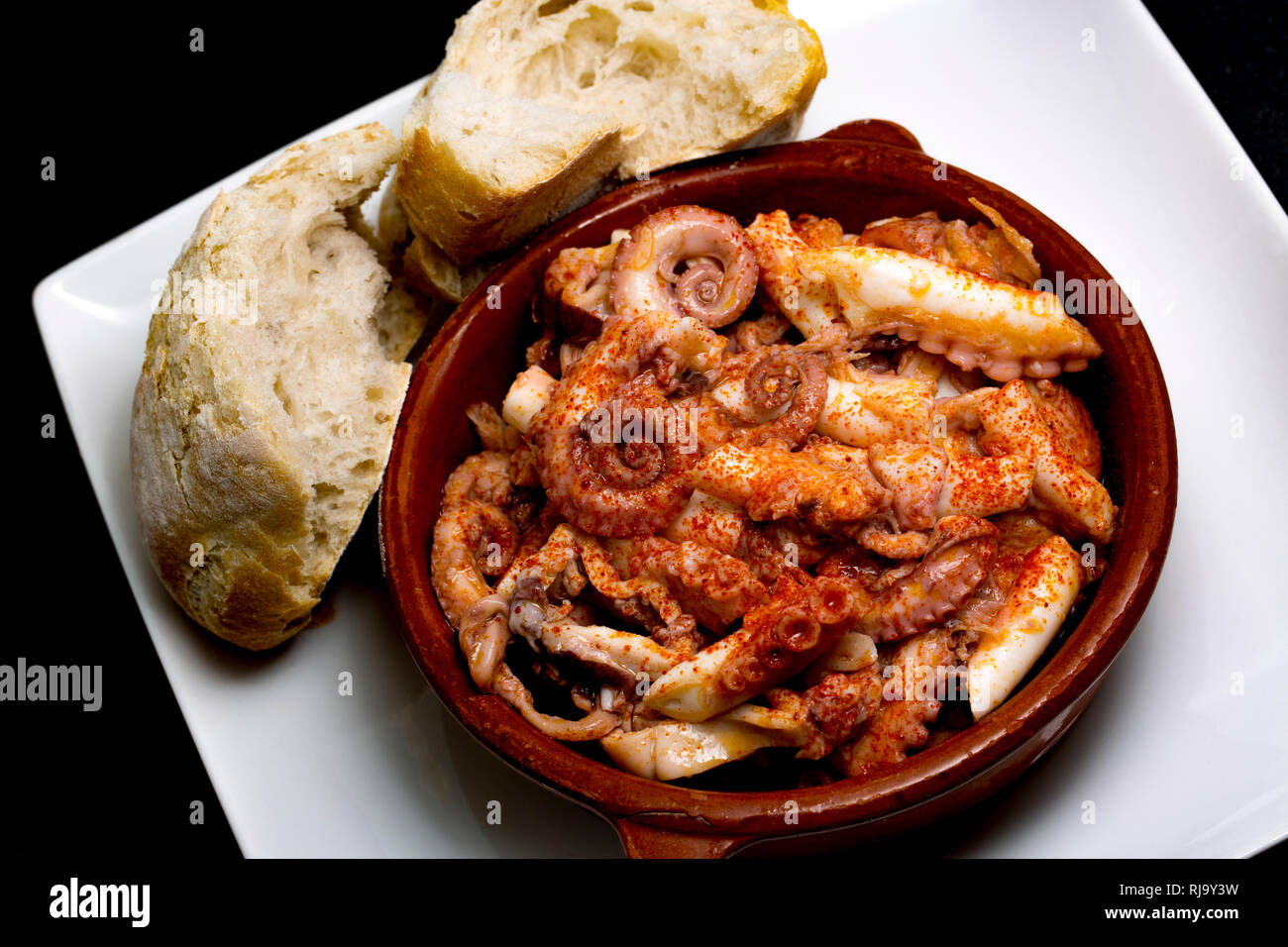 A dish of Galician octopus, or pulpo gallego, made from a lesser, or curled, octopus, Eledone cirrhosa, caught in UK waters and  bought from a superma Stock Photo