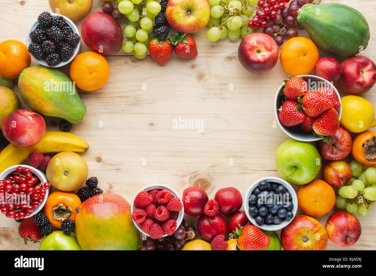 Rainbow Fruits Background Frame Strawberries Raspberries Oranges Plums Apples Kiwis Grapes Blueberries Mango Persimmon On Light Wooden Table Stock Photo Alamy