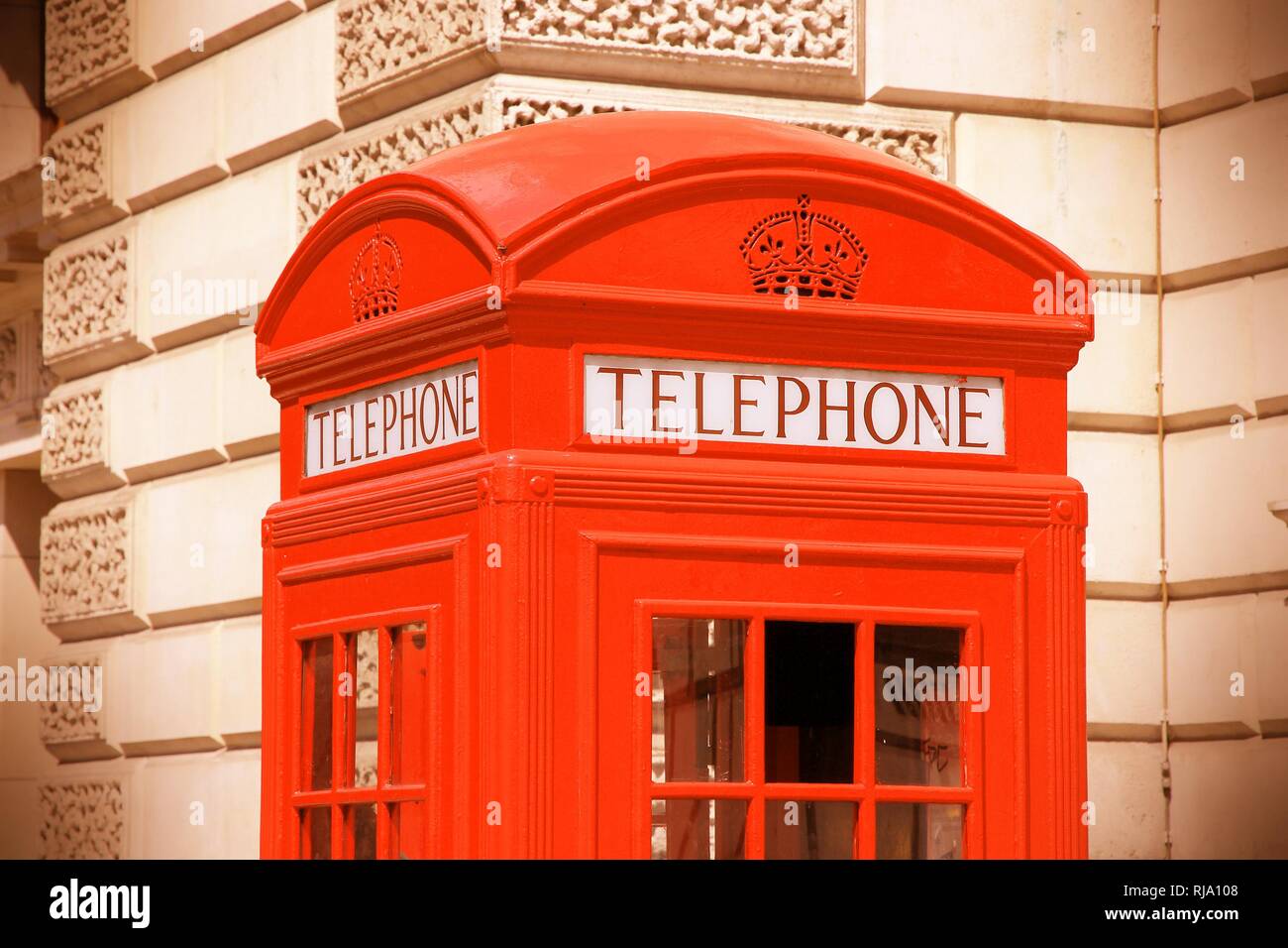 London, United Kingdom red telephone box closeup. Cross processing