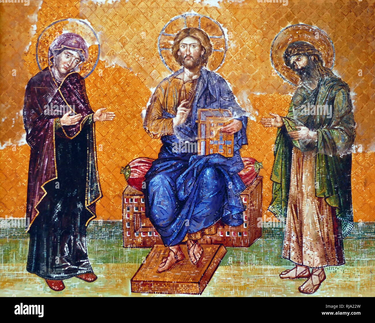 Virgin Mary; Jesus Christ and John the Baptist, depicted on an 13th Century, Byzantine mosaic; Hagia Sofia, Istanbul, Turkey. Hagia Sophia is a former Greek Orthodox, Christian church, later an Ottoman imperial mosque and now a museum. Built in 537 AD at the beginning of the Middle Ages, it was famous in particular for its massive dome. It was the world's largest building and an engineering marvel of its time. Stock Photo