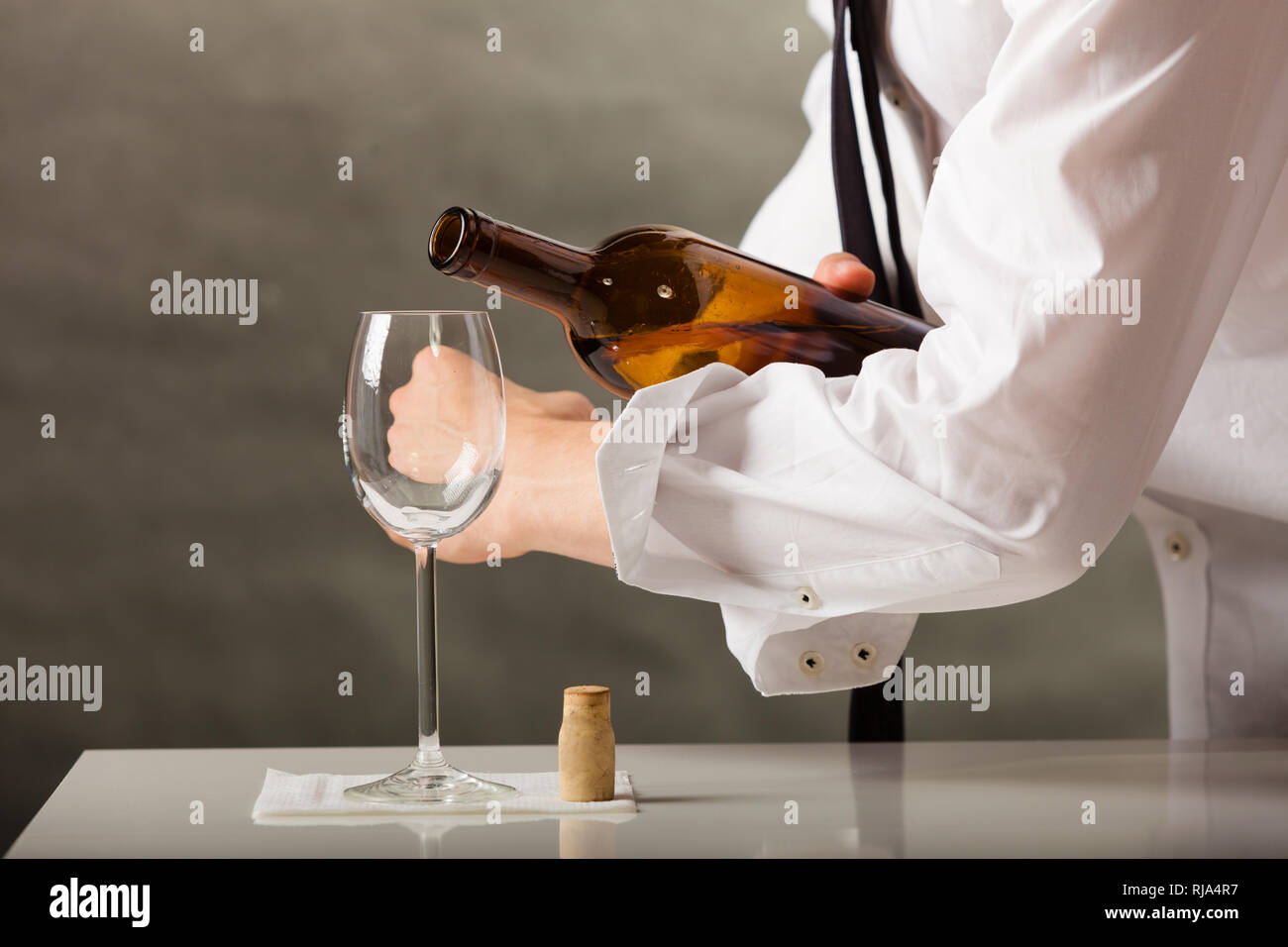 Male waiter or butler serving pouring wine into glass Stock Photo Alamy