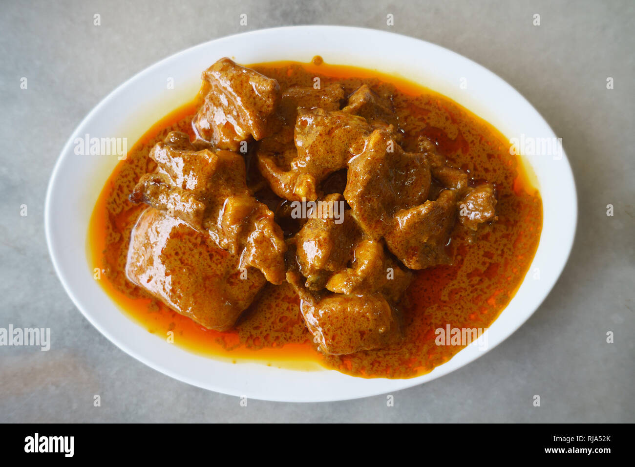 Malaysian street food a delicious Indian mutton curry on table setup. Stock Photo