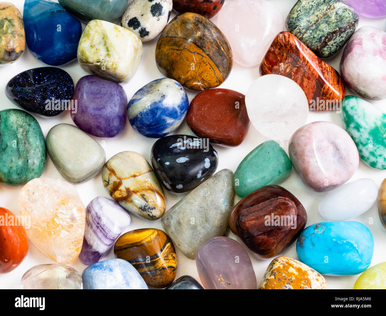 many various gemstones on white board close up Stock Photo