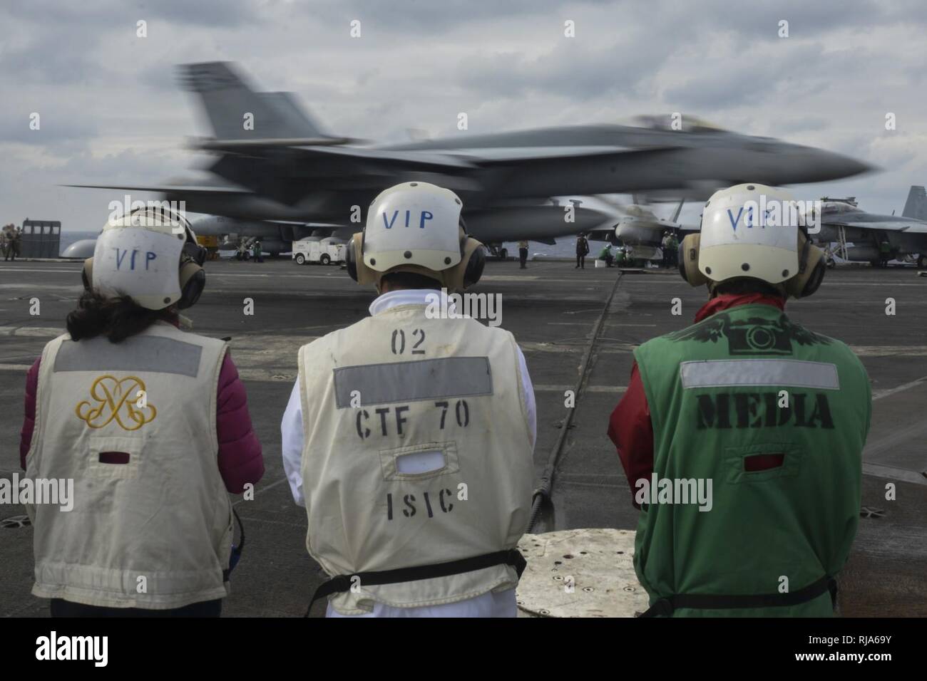 PHILIPPINE SEA (Nov. 1, 2016) Visitors from Japan watch as an F/A-18E Super Hornet, assigned to the “Dambusters” of Strike Fighter Squadron (VFA) 195, lands on the flight deck of the Navy’s only forward-deployed aircraft carrier, USS Ronald Reagan (CVN 76), as part of Exercise Keen Sword 2017 (KS17). KS17 is a joint, bilateral field-training exercise involving U.S. military and Japanese Maritime Self-Defense Force personnel, designed to increase combat readiness and interoperability of the Japan-U.S. alliance. Stock Photo