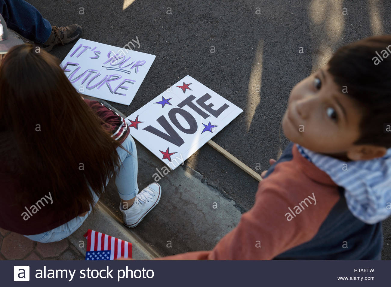 Latinx boy volunteering, canvassing voters Stock Photo