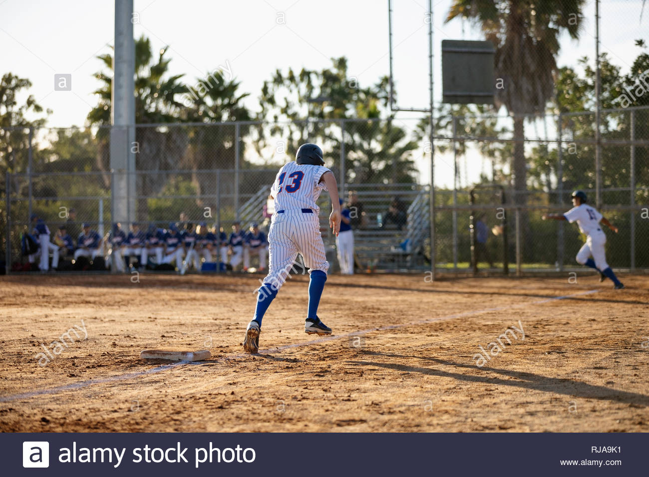 Baseball player running for home base on field Stock Photo Alamy
