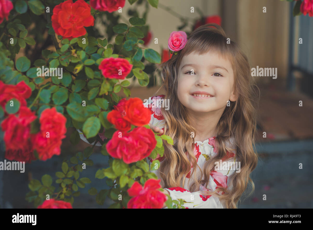 Cute Baby Girl With Blond Curly Hairs And Happy Bright Child Eyes