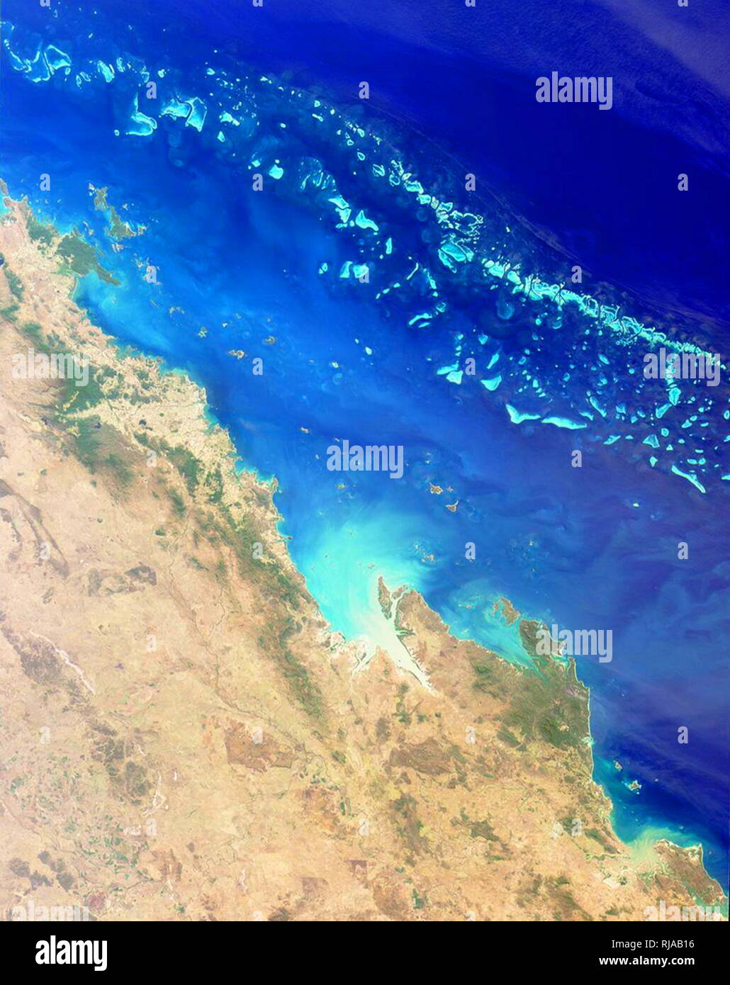The Great Barrier Reef viewed from earth orbit in 2001. The reef extends for 2,000 kilometres along the north-eastern coast of Australia. It is not a single reef, but a vast maze of reefs, passages, and coral cays (islands that are part of the reef). photographed from the Terra Spacecraft, Multi-angle Imaging Spectroradiometer (MISR) Stock Photo