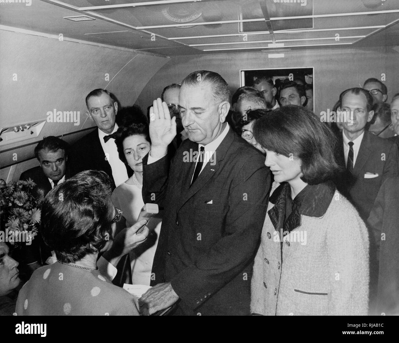 inauguration of Lyndon B. Johnson as President of the United States; November 22, 1963; aboard Air Force One at Love Field. This followed the assassination of President John F. Kennedy, earlier that day. Lyndon B. Johnson taking the oath of office on Air Force One following the assassination of John F. Kennedy, Dallas, Texas. Judge Sarah T. Hughes administered the oath as Jacqueline Kennedy looked on. Stock Photo