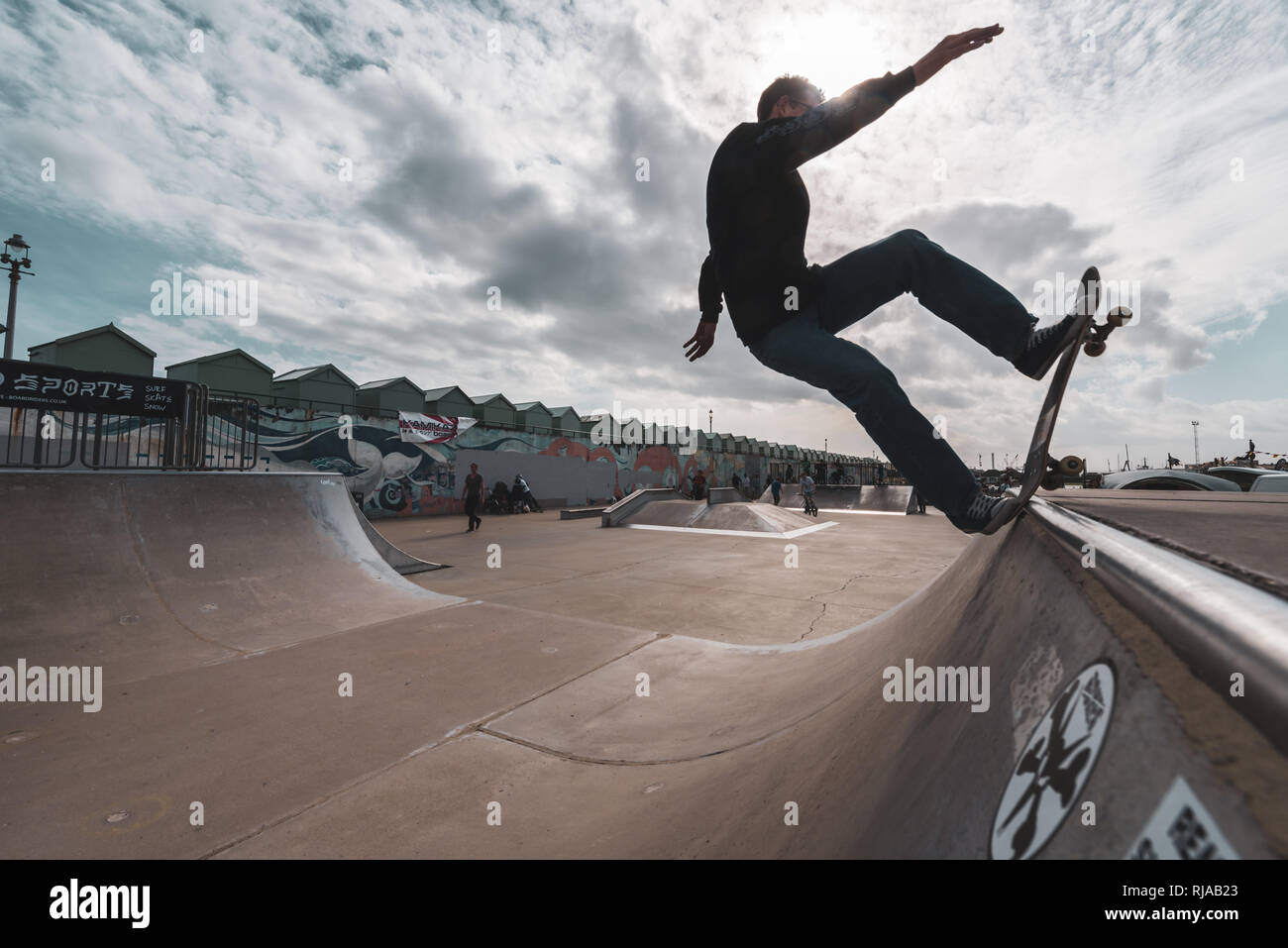 A man skating performs a trick on a ramp at the Hove Lagoon Skatepark,  Hove, Brighton, England Stock Photo - Alamy