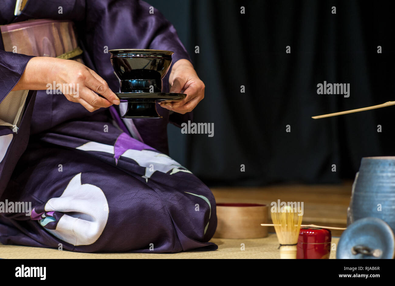 a japanese woman shows the tea ceremony during a public demonstration