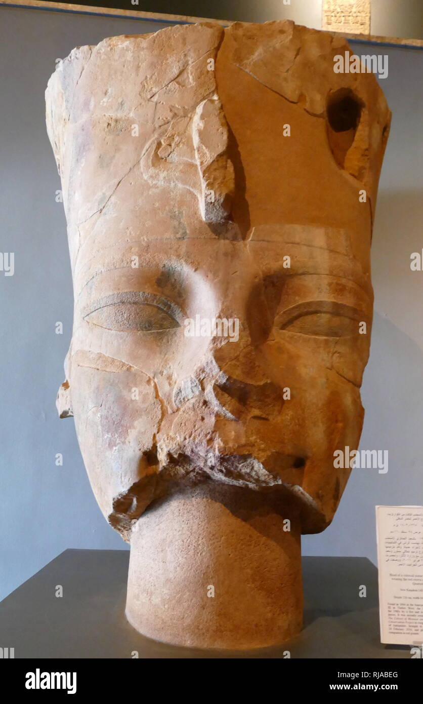 Colossal head of Amenhotep III wearing the Red Crown of Lower Egypt. Quartzite; New Kingdom 1403-1365 BC found in the funerary temple of King Amenhotep III in Thebes. Stock Photo