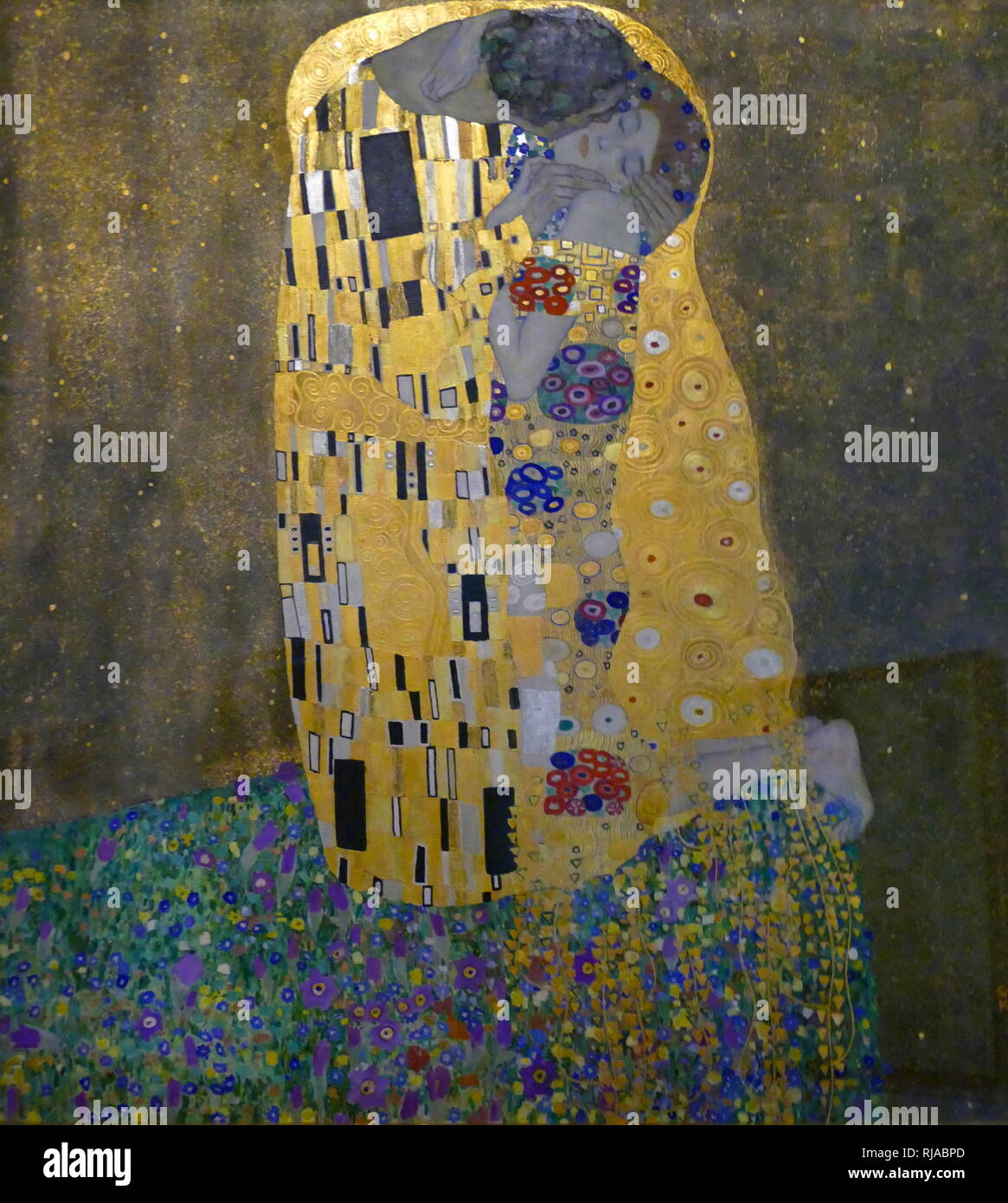 The Kiss (Klimt painting), a 1907 golden painting by Gustav Klimt. The Kiss (Liebespaar) is an oil, gold, and silver-leaf painting by the Austrian Symbolist painter Gustav Klimt, and was painted between 1907 and 1908 during the height of Klimt's 'Golden Period'. The painting depicts a couple embracing one another, their bodies entwined in elaborate robes decorated in a style influenced by the contemporary Art Nouveau style Stock Photo