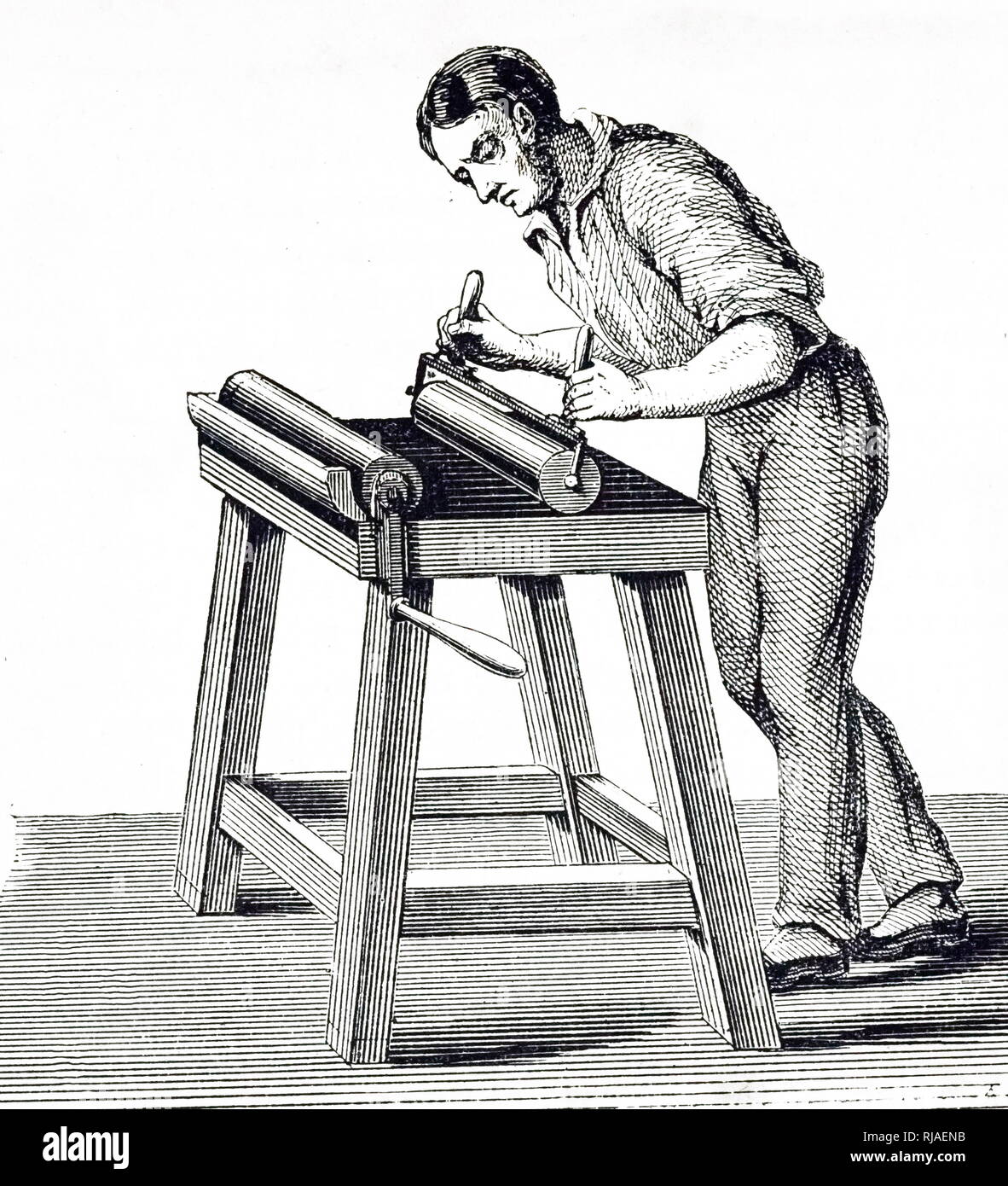 An engraving depicting a man using a roller to apply ink to type in a forme. Dated 19th century Stock Photo