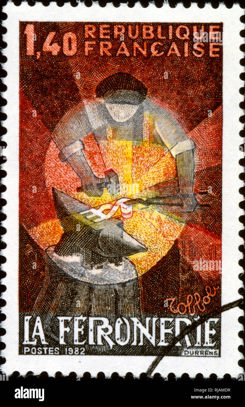 1982, French postage stamp depicting a blacksmith or ironworks Stock Photo