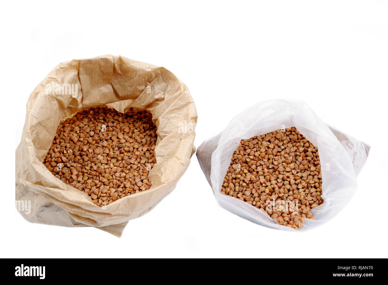 Buckwheat in a plastic and paper bag. Natural useful dietary product.Ecological in contrast to non recyclable packaging concept.Grocery concept Stock Photo